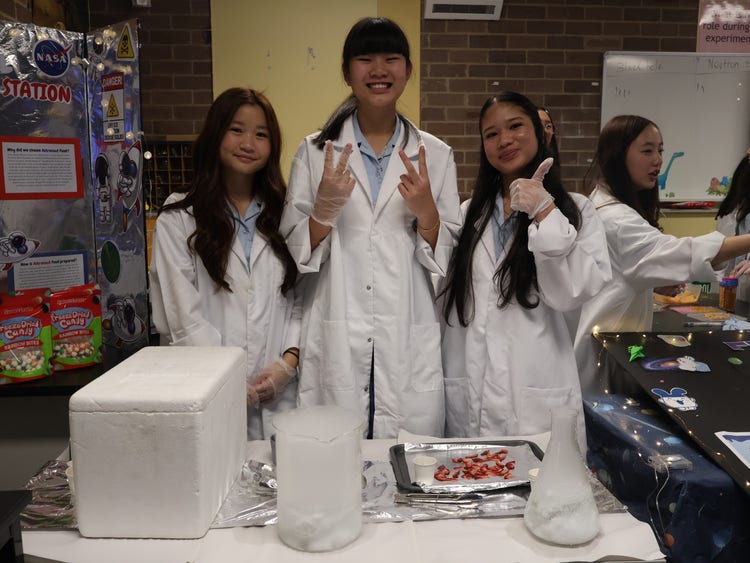 Students organising an experiment for Science Week Show