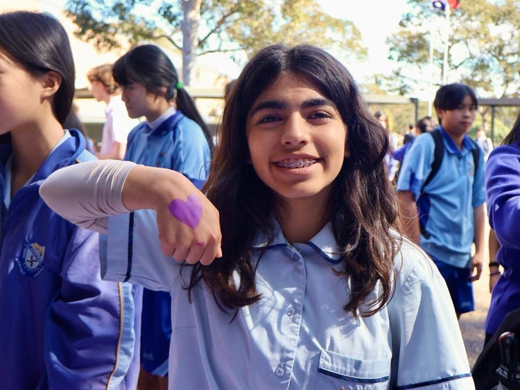 A student participating in Wear it Purple Day