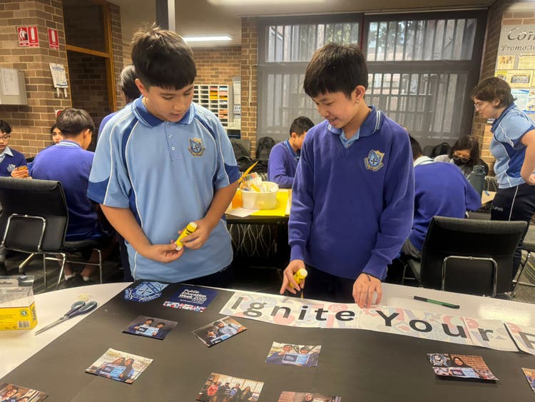 Students working on a poster for Education Week