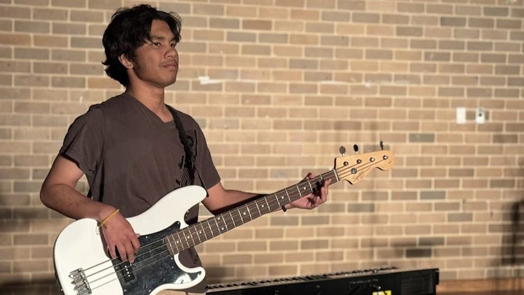 Student playing the guitar at the showcase
